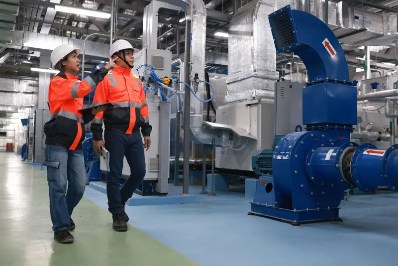 Two technicians walking through a commercial mechanical room